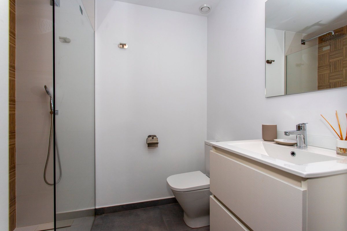 Bathroom with walk-in shower, vanity unit and mirror