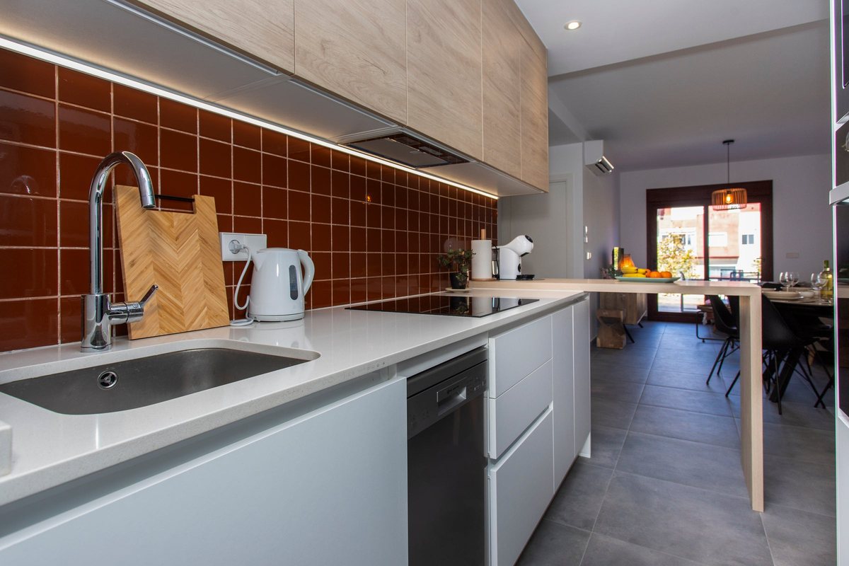Sink and dishwasher, with a view through to the living room