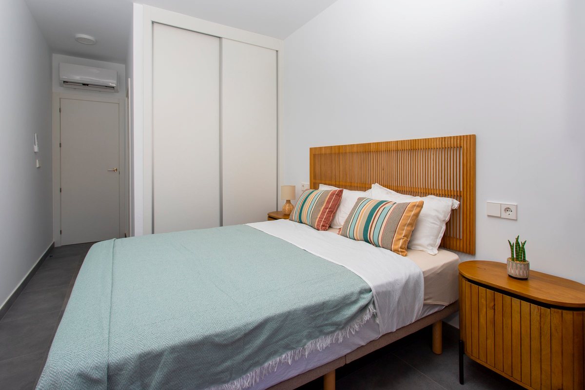 Main bedroom with built-in wardrobe, air conditioning and bedside tables