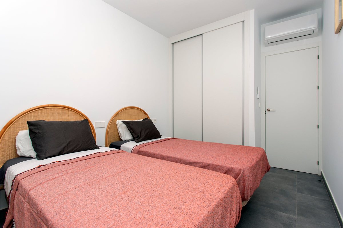 Bedroom with two single beds, built-in wardrobe and air conditioning