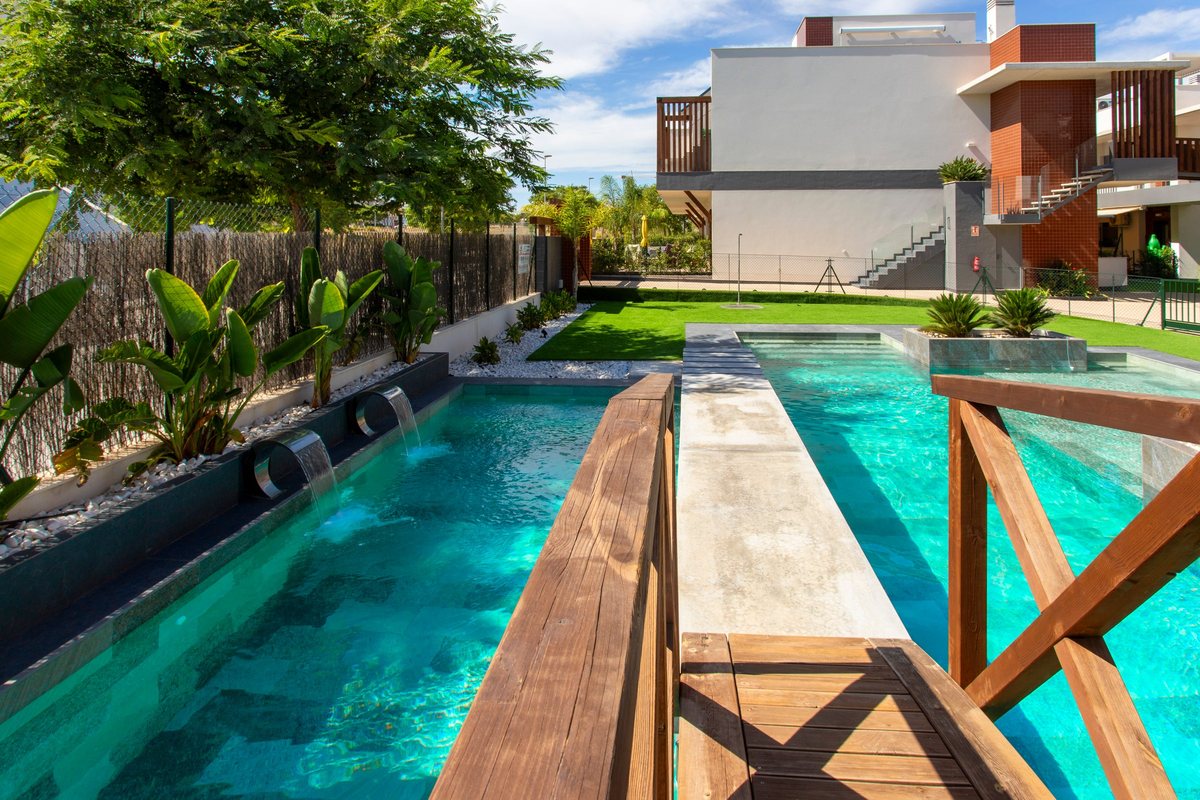 Wooden bridge over the pool with water spouts